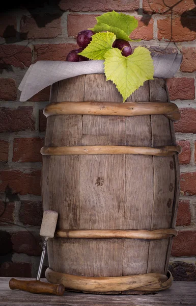 Grapes on a wooden vintage barrel with corkscrew