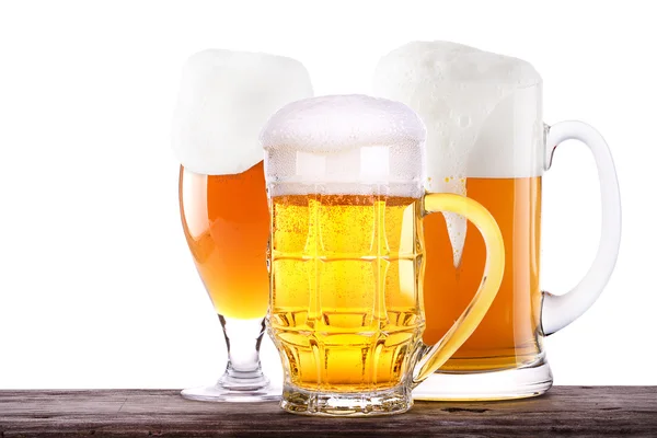 Beer glass on wooden barrel background — Stock Photo, Image