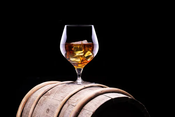 Cognac or brandy on a wooden barrel — Stock Photo, Image