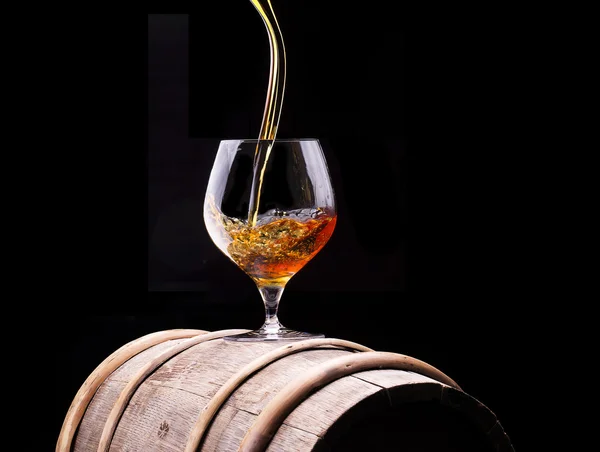 Cognac or brandy on a wooden barrel — Stock Photo, Image