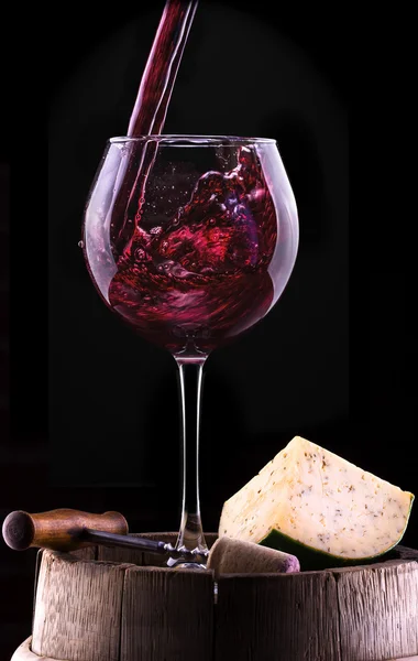 Splash vinho tinto contra um fundo preto — Fotografia de Stock