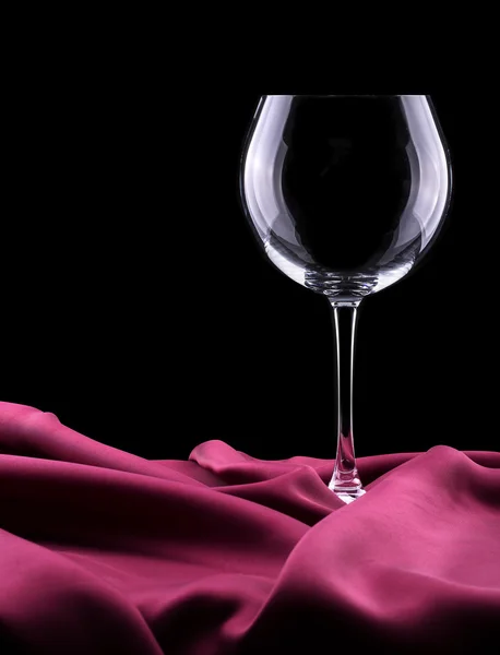 Empty Glass on red silk — Stock Photo, Image