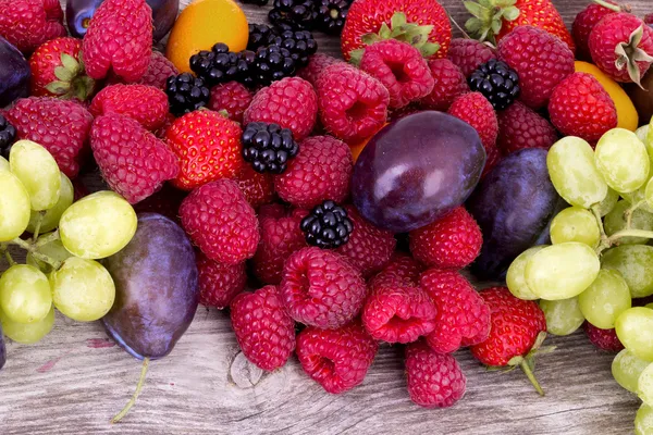 Tasty summer fruits on a wooden table — Stock Photo, Image