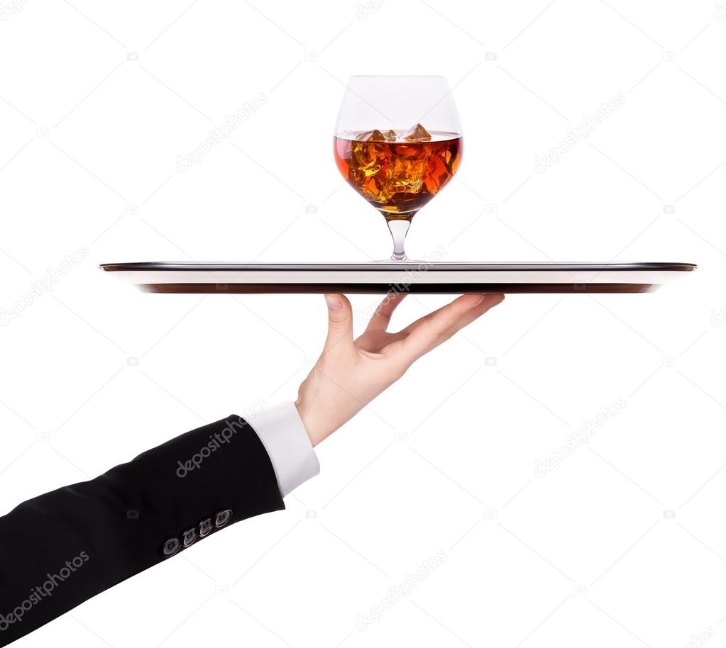 Waiter holding silver tray with brandy