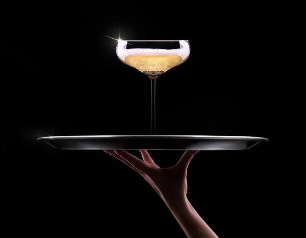 Servitören hand med champagne — Stockfoto
