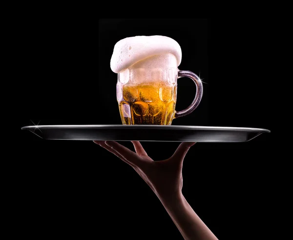 Beer into glass on a black — Stock Photo, Image