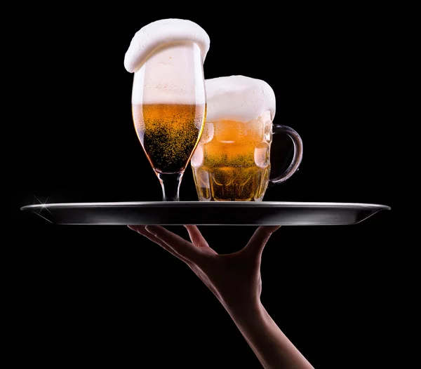 Beer into glass on a black — Stock Photo, Image