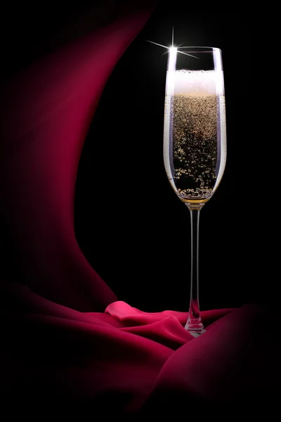 Champagne glass on black and red silk — Stock Photo, Image