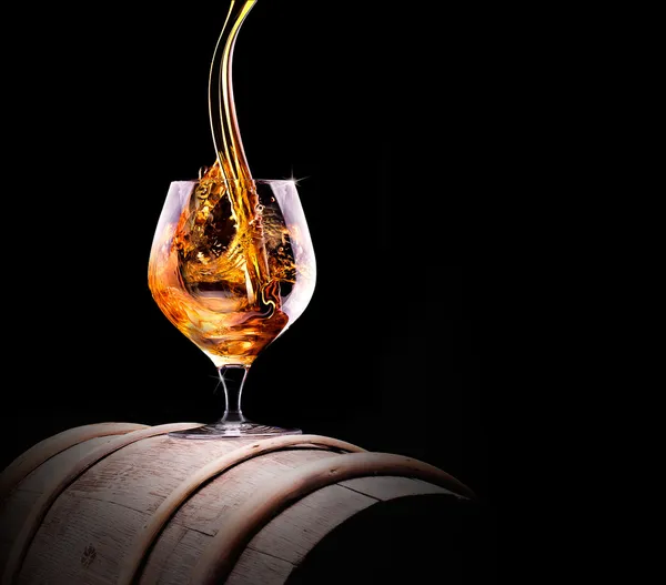 Cognac or brandy on a black — Stock Photo, Image