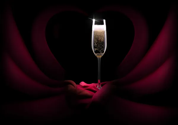 Champagne glass on black and red silk — Stock Photo, Image