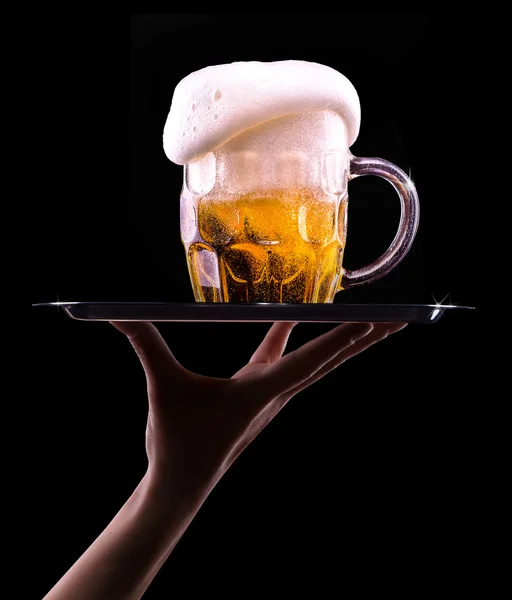 Beer into glass on a black — Stock Photo, Image