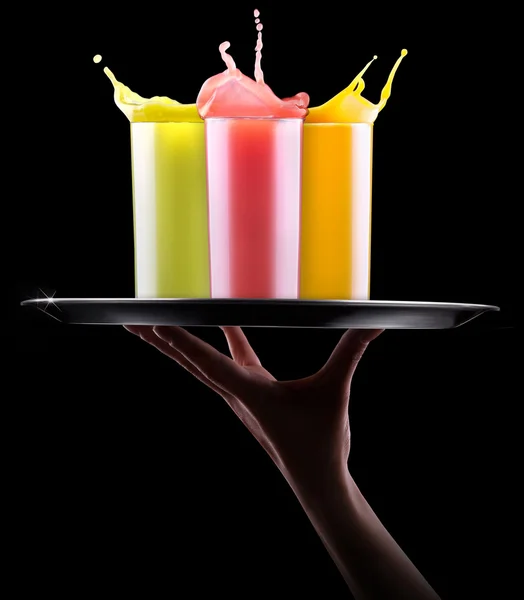 Tasty summer fruit drinks with splash on tray — Stock Photo, Image