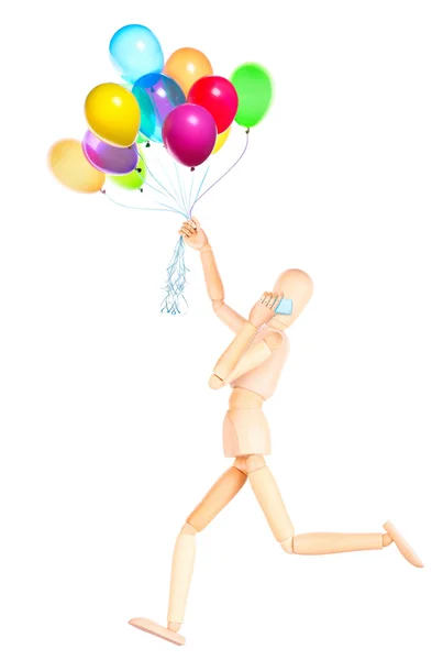 Holzattrappe mit Luftballons, die auf dem Handy sprechen — Stockfoto