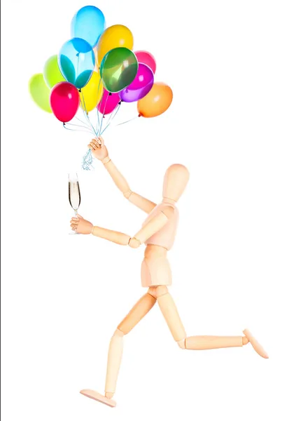Wooden Dummy with champagne holding balloons — Stock Photo, Image