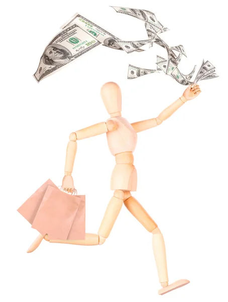 Wooden Dummy with shopping bags and money — Stock Photo, Image