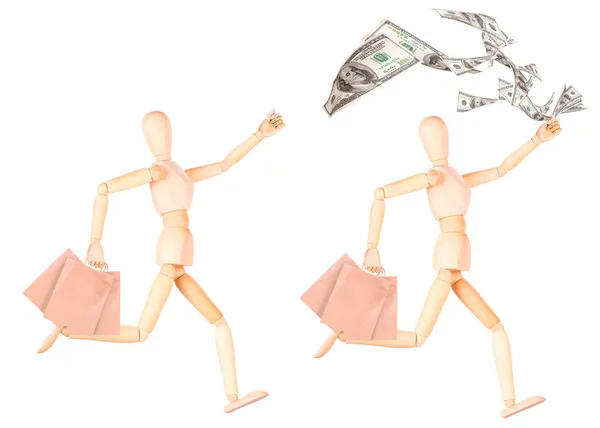Wooden Dummy with shopping bags and money — Stock Photo, Image