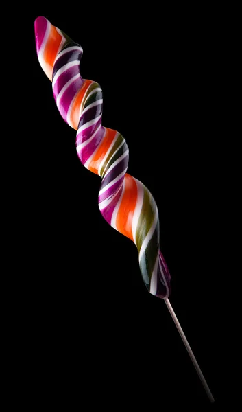 Heldere kleurrijke lollipop op zwarte achtergrond — Stockfoto