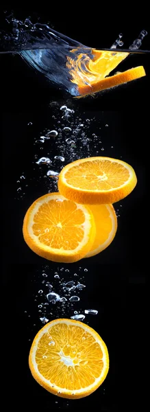 Slice of orange in the water with bubbles — Stock Photo, Image