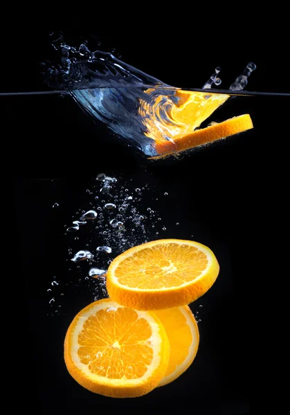 Slice of orange in the water with bubbles — Stock Photo, Image