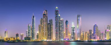 Palm Jumeirah, Birleşik Arap Emirlikleri Dubai Marina defne görünümünden on sunset altın yansıması ile modern binalar.