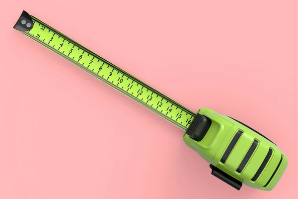 Green carpenter measuring tape isolated on pink with imperial units scale. — Stock Photo, Image