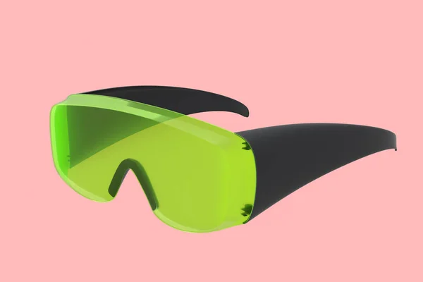 Protective green plastic dentist glasses isolated on pink background — Stock Photo, Image
