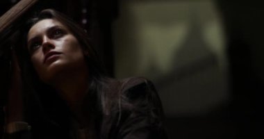 Kapatın. Kahverengi ceketli üzgün esmer kadın evde merdivenlerde tek başına oturmuş tırabzana yaslanıyor. Sinirli bayan karanlık koridorda merdivenlerde oturuyordu. Yalnızlık kavramı