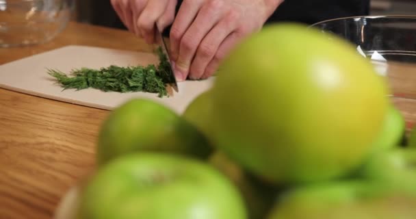 Slow motion near the chef hand is chopped fresh herbs dill. — Stock Video