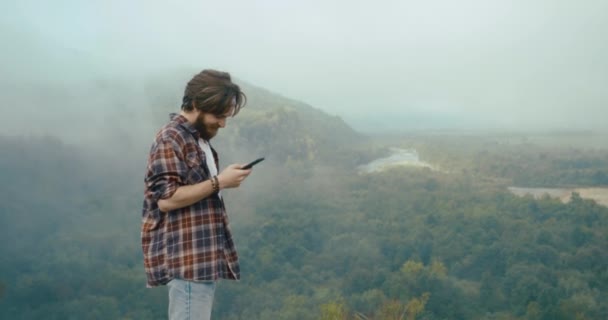 Young Hypster Man Chats Someone His Phone Standing Top Rock – stockvideo