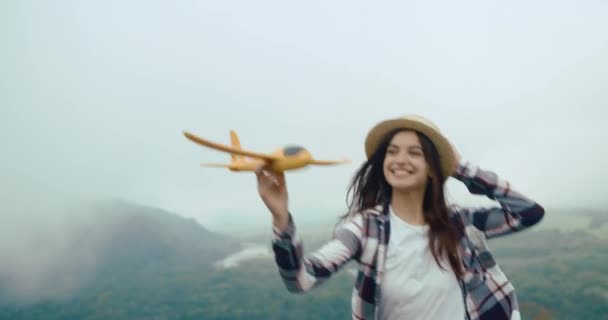 Happy Young Girl Hat Plays Little Yellow Airplane Running Rock — Stok Video