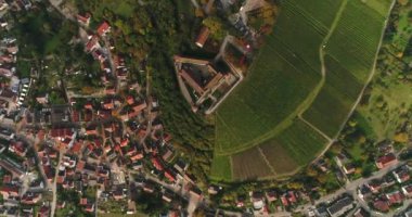 Top panorama view of the beautiful sunny town Weinsberg in Heilbronn district, Germany. Flying copter over historic Stettenfels Castle and its vineyards