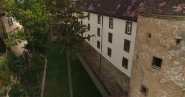 Weinsberg in Heilbronn district, Germany. Flying copter up. Close-up view of the historic Stettenfels Castle surrounded by green blooming vineyards
