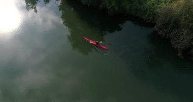 Copter is following the man kayaking along the beautiful River Main in Heilbronn, Germany. 4k footage