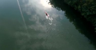 Following copter over kayaking man along the Nacker river in Heilbronn, Germany. 4k footage. Top view
