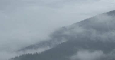 The misty mountains view. 4k footage. Slowly moving clouds