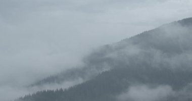 Nature view of mountains covered with thick fog. 4k footage