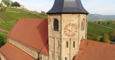 Circling around the old historic Johanneskirche in beautiful sunny Weinberg town in Germany. Heilbronn district. Footage 4k