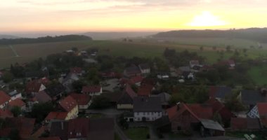 Charming greeny nature of the little rustic town Weinsberg in Heilbronn district, Germany during the sunset. 4k footage. Aerial flight