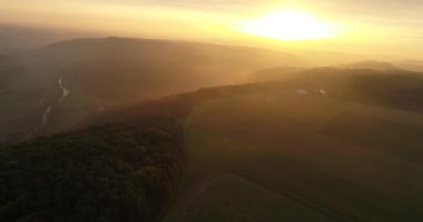 Beautiful panorama view of Heilbronn nature, Germany. Flying copter over fields and greeny mountains covered with must during the sunset. 4k footage