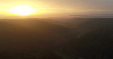 Beautiful sunset in Heilbronn, Germany. Panorama view of the mountains covered with thick forests and fog during the sunset
