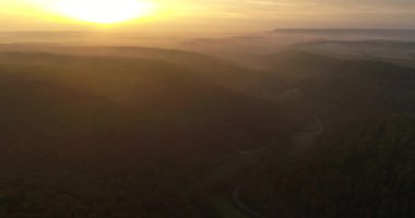 Aerial copter flight over beautiful greeny mountains covered with fog during the sunset in Heilbronn, Germany. 4k footage
