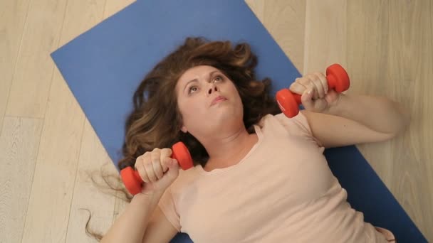 View Obese Young Woman Gaining Weight Help Dumbbells While Lying — Stock Video
