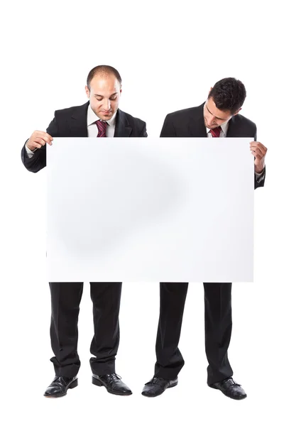 Två affärsman innehar en skylt — Stockfoto