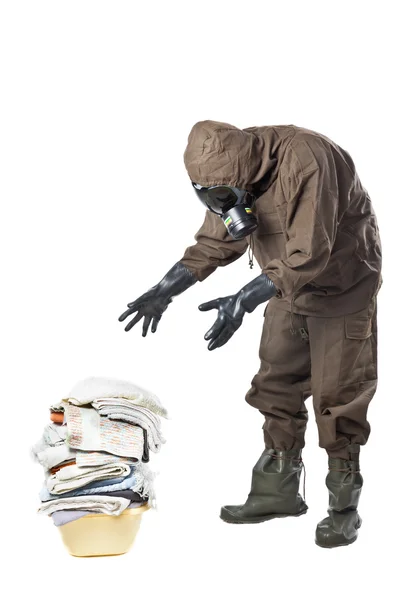 Man in Hazard Suit looking at dirty laundry — Stock Photo, Image