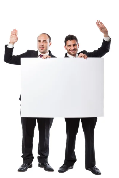 Dwóch biznesmenów, pozdrawiając i gospodarstwa billboard — Zdjęcie stockowe