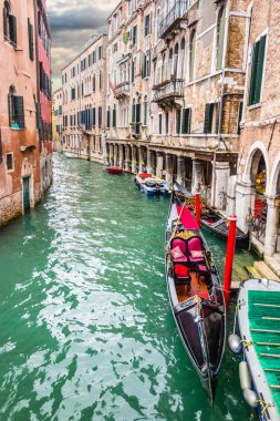 Gondola in a narrow canal clipart