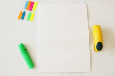 A4 paper on office table, supplies, pen, phone, blank paper