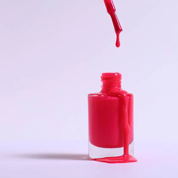 Bottle of pink nail polish, enamel smear