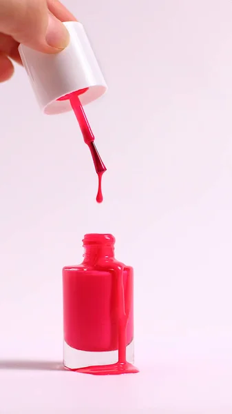 Bottle of pink nail polish, enamel smear