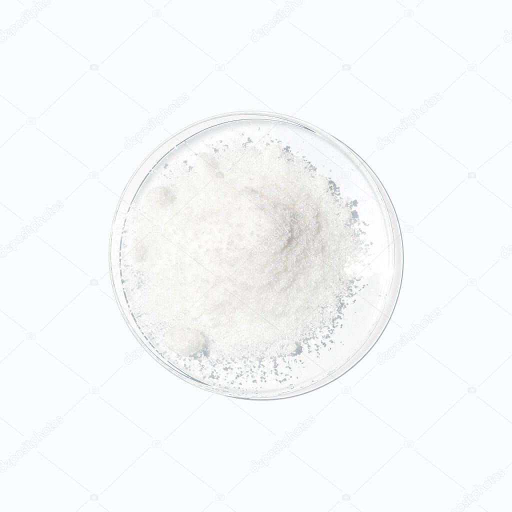 Closeup chemical ingredient on white laboratory table. Di-Ammonium Prosphate in Chemical Watch Glass. Top View